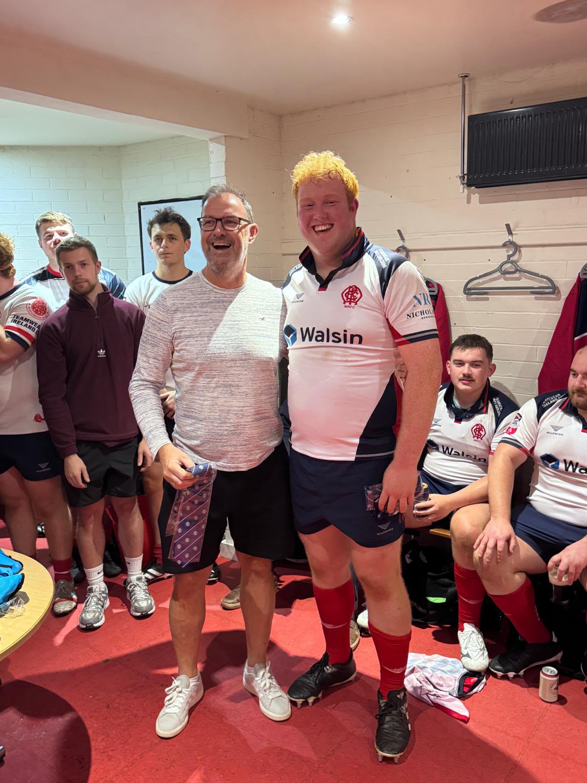 Malone debutant receiving his AIL cap tie in the changing room