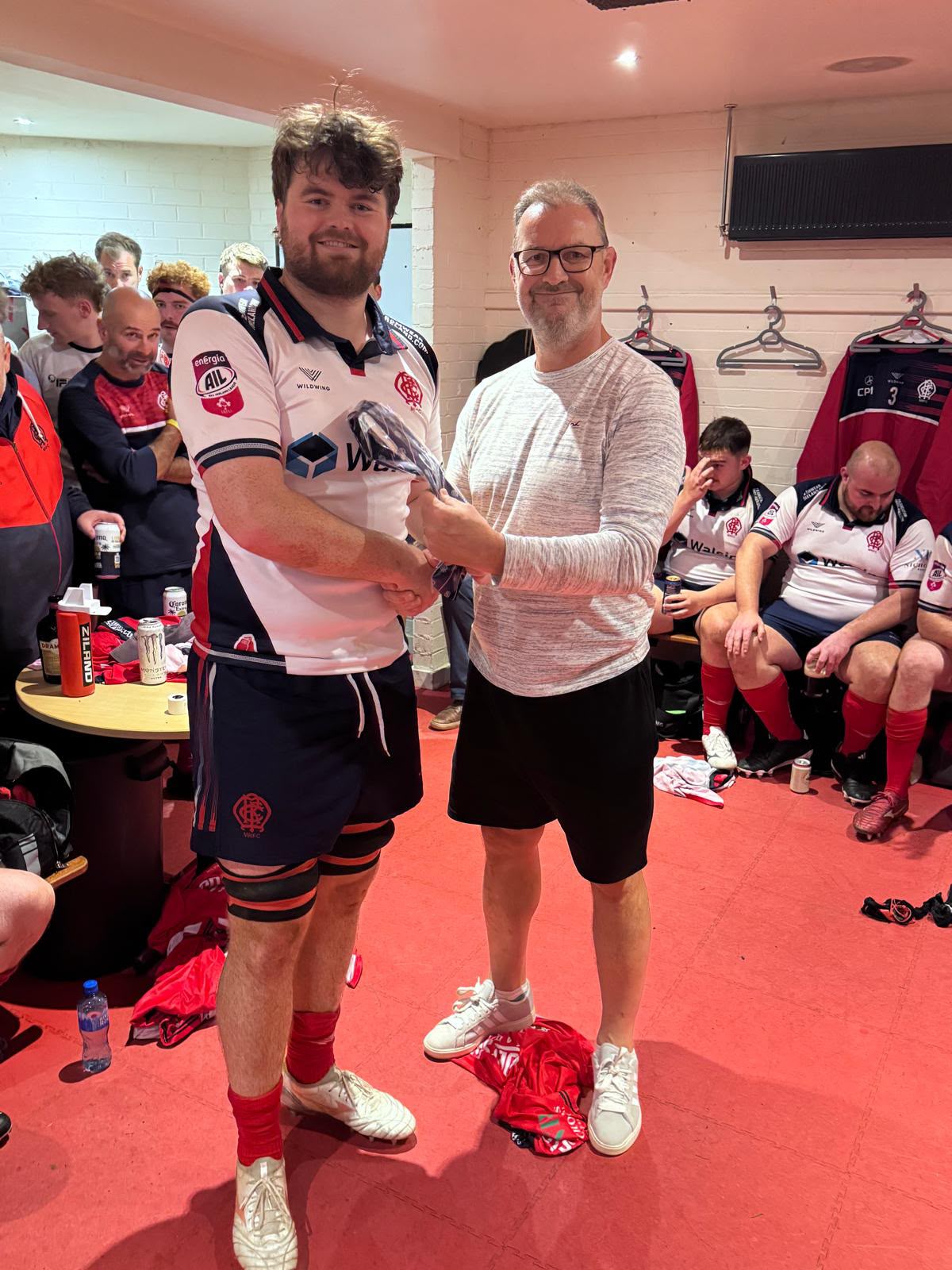 Malone debutant receiving his AIL cap tie in the changing room