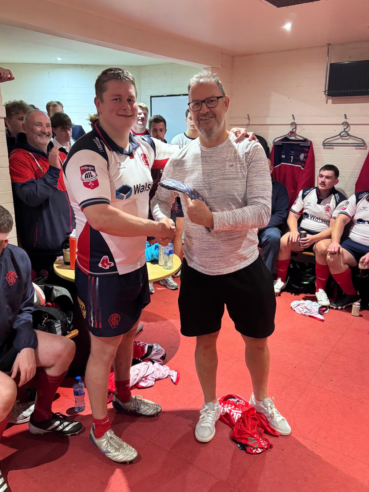 Malone debutant receiving his AIL cap tie in the changing room